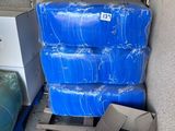 a stack of blue plastic containers sitting on a pallet