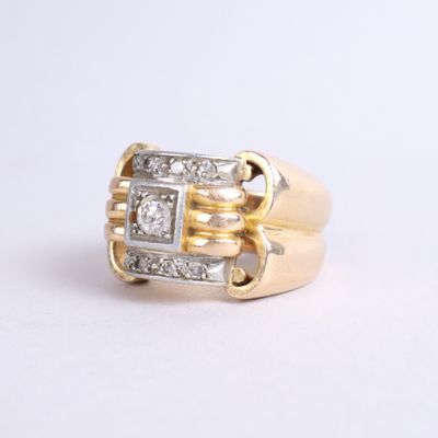 an image of a gold and diamond ring on a white surface
