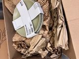 a cardboard box with a white cross on top of it