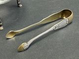 two spoons and a spoon rest on a table