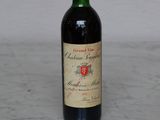 a bottle of wine sitting on a marble counter top
