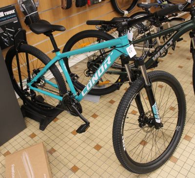 two bikes that are sitting on the floor in a store