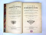 a book opened on top of a table on a white surface