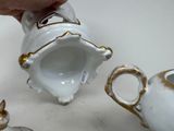 a person that is putting something in a tea pot