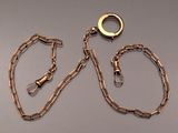 a gold chain with a ring on it and a chain with a ring on it