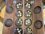a lot of nuts in a wooden tray on a table