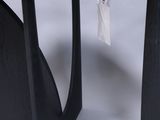 pair of black side tables on a white background with a tag on the top