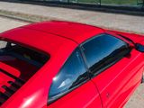 a red sports car parked on the side of the road