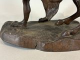 bronze statue of a bull and a horse fighting on a rock