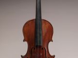 an old violin sitting on top of a table next to a wall