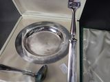 a silver plate with a spoon and fork in a box