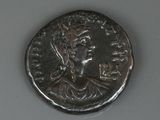 an ancient roman coin with a woman ' s face on it