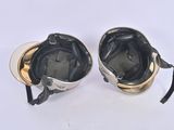 pair of black and gold ski goggles on a white surface