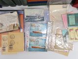 many different types of postcards and envelopes laid out on a table