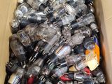 a cardboard box full of empty bottles in a room