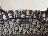 the purse is made of fabric and has a black and white pattern