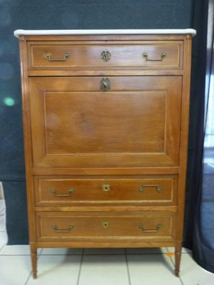 a wooden chest of drawers with a marble top