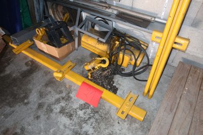 a yellow machine that is sitting in a garage