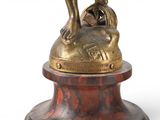 a statue of a man riding a horse on top of a pedestal