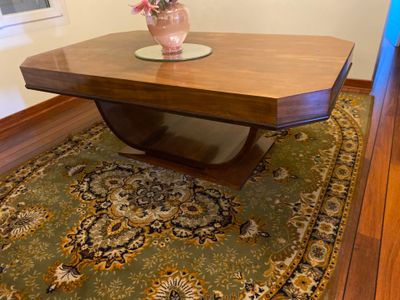 a table with a vase of flowers on top of it