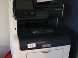a red barrel with a printer on top of it