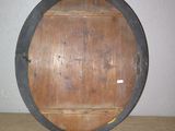 a wooden wall with a metal frame and a clock on it