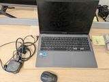 a laptop computer sitting on a desk next to a mouse