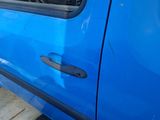 a blue car that is parked on the side of the street