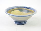 a blue and white bowl sitting on a white surface