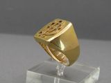 a picture of a gold signet ring on a clear stand
