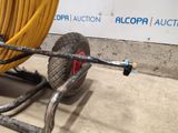 a wheel with a hose attached to it and a hose attached to the cart