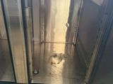 a dirty floor in a commercial kitchen with stainless steel cabinets