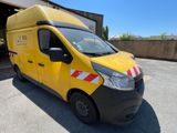 the yellow van is parked in front of a building