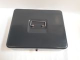 a black metal box with a handle on a white surface