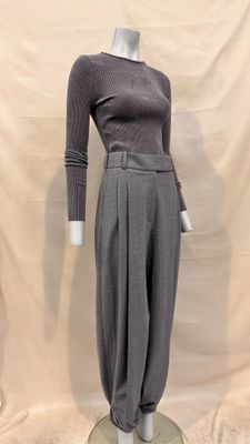 the mannequin is wearing a gray sweater and pants
