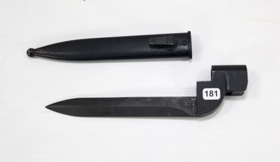 two knives on a white surface one has a number on it