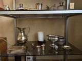 a shelf that has a lot of silver items on it