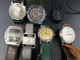a lot of watches that are sitting on a table