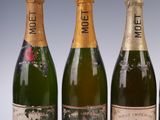 three bottles of champagne sitting next to each other on a table