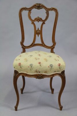 an image of a chair with a floral upholstered seat