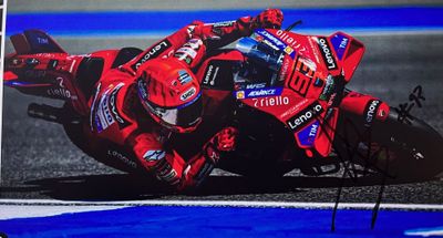 signed photo of a motorcycle racer leaning over on a track