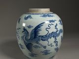 a blue and white vase with a bird on it