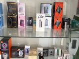 a glass display case filled with many different types of electronic devices