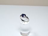 a ring with a blue stone in it sitting on a table