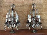 two lamps that are sitting on a wooden shelf
