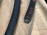 a close up of a black hose on a wooden table
