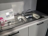 a sink and a microwave in a small room