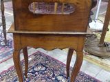 a wooden chair that is sitting on a rug