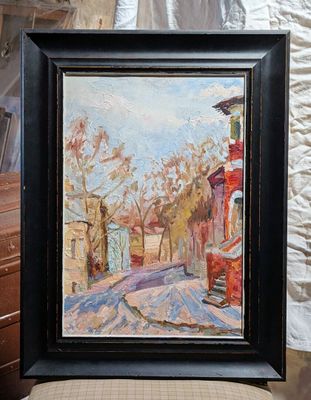 a picture of a painting on a chair in front of a wall