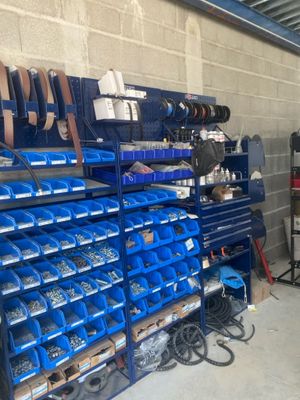 a lot of blue bins on the shelves in the garage